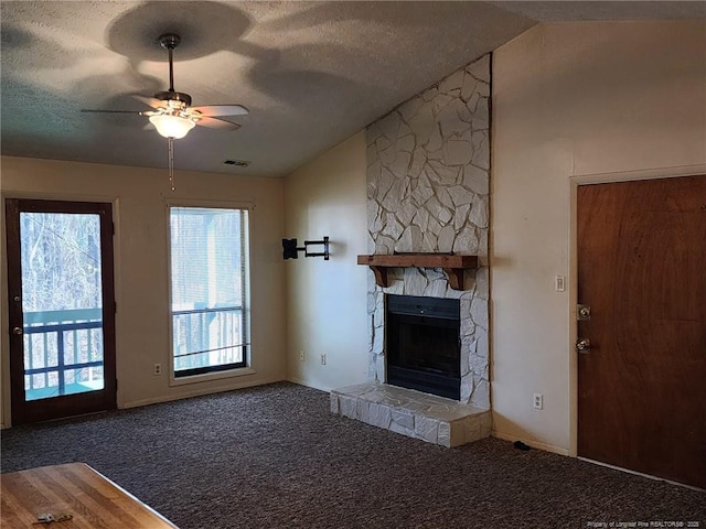 1900 Tryon Dr Unit 6, Fayetteville, NC 28303 - unfurnished living room with ceiling fan, a textured ceiling, a stone fireplace, carpet, and lofted ceiling