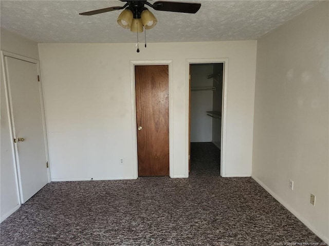 1900 Tryon Dr Unit 6, Fayetteville, NC 28303 - unfurnished bedroom featuring carpet flooring, a textured ceiling, a walk in closet, and a ceiling fan