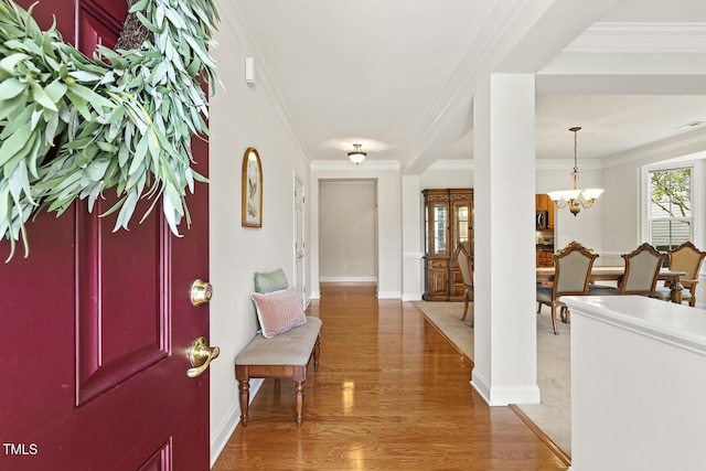 400 Indian Elm Ln, Cary, NC 27519 - entryway featuring ornamental molding, a chandelier, and light wood finished floors