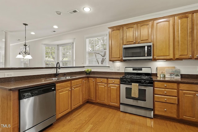 400 Indian Elm Ln, Cary, NC 27519 - kitchen with appliances with stainless steel finishes, ornamental molding, light wood-type flooring, recessed lighting, and brown cabinets