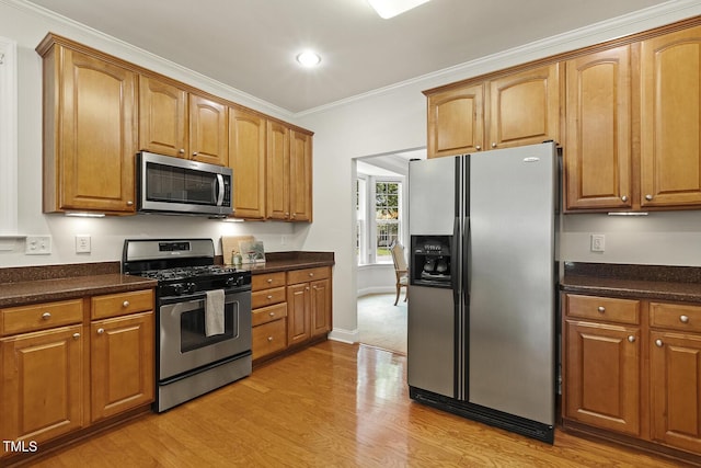 400 Indian Elm Ln, Cary, NC 27519 - kitchen with appliances with stainless steel finishes, light wood-style floors, crown molding, brown cabinetry, and recessed lighting