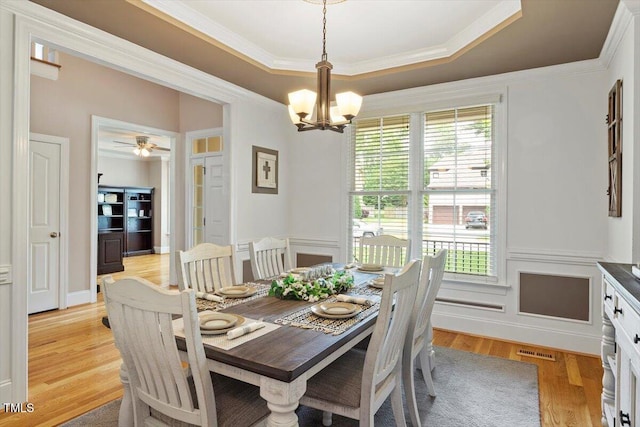 10012 San Remo Pl, Wake Forest, NC 27587 - dining space with a chandelier, ornamental molding, light wood finished floors, a raised ceiling, and ceiling fan