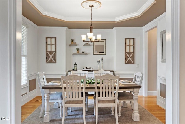 10012 San Remo Pl, Wake Forest, NC 27587 - dining area with light wood-style floors, crown molding, a chandelier, and a tray ceiling