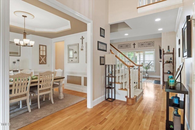 10012 San Remo Pl, Wake Forest, NC 27587 - foyer featuring light wood-style floors, stairway, a chandelier, and crown molding