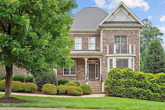 10012 San Remo Pl, Wake Forest, NC 27587 - view of front facade featuring brick siding and a balcony