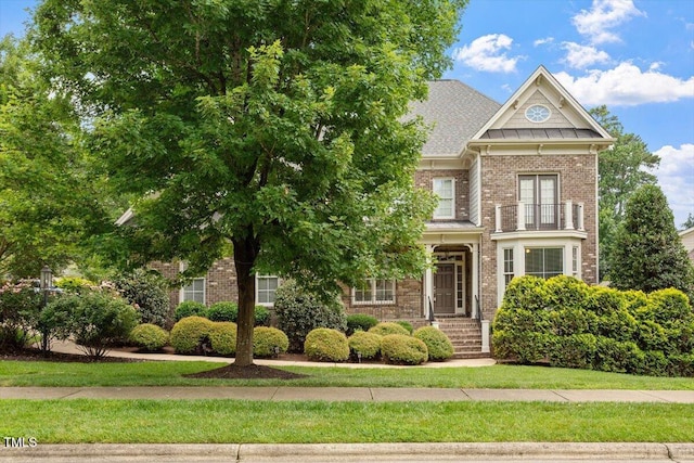 10012 San Remo Pl, Wake Forest, NC 27587 - view of front of home with a balcony and brick siding