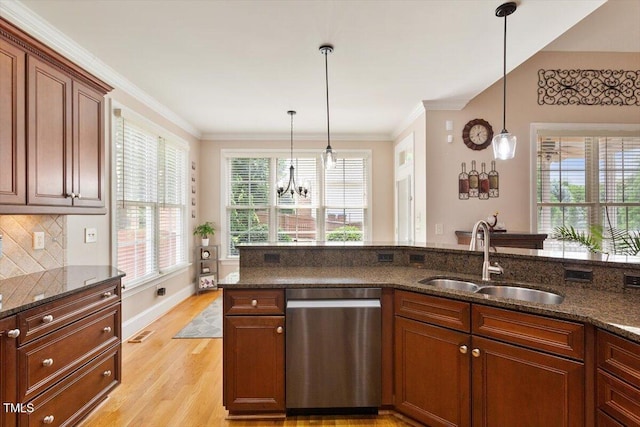 10012 San Remo Pl, Wake Forest, NC 27587 - kitchen featuring dishwasher, dark stone countertops, hanging light fixtures, light wood-style flooring, and crown molding