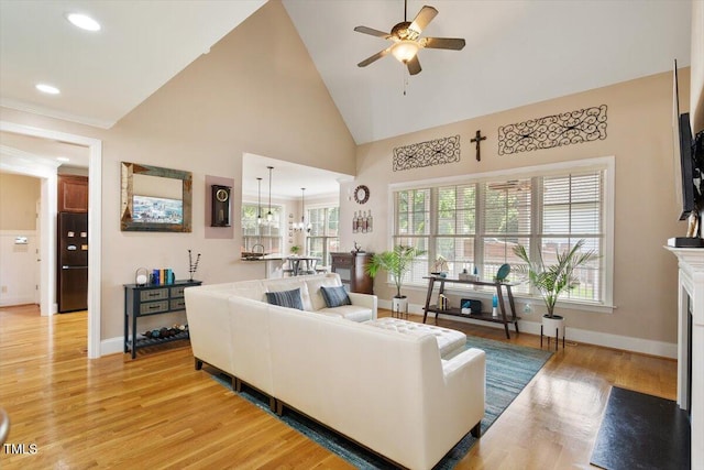 10012 San Remo Pl, Wake Forest, NC 27587 - living area featuring ceiling fan, light wood finished floors, high vaulted ceiling, recessed lighting, and a fireplace with flush hearth