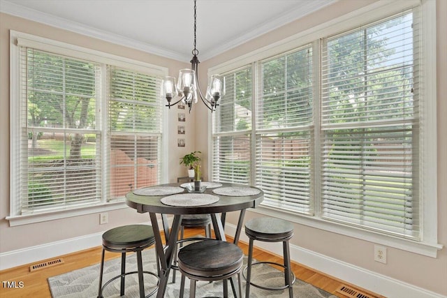 10012 San Remo Pl, Wake Forest, NC 27587 - dining room featuring a chandelier, ornamental molding, and wood finished floors
