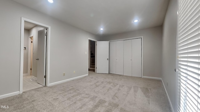 933 Creek Side, Fayetteville, NC 28303 - unfurnished bedroom featuring recessed lighting, light carpet, connected bathroom, and a closet