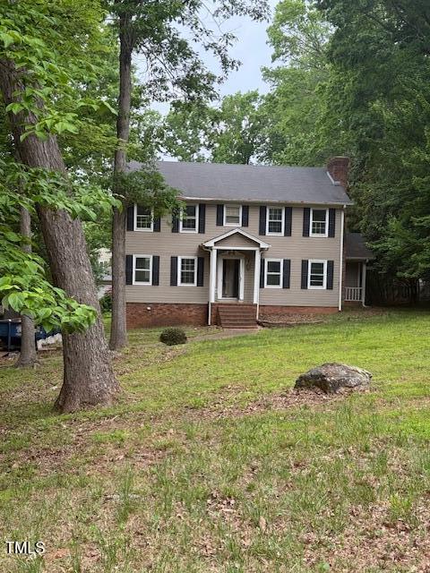 1821 Back Creek Ct, Asheboro, NC 27205 - colonial house featuring a chimney, a front yard, and entry steps