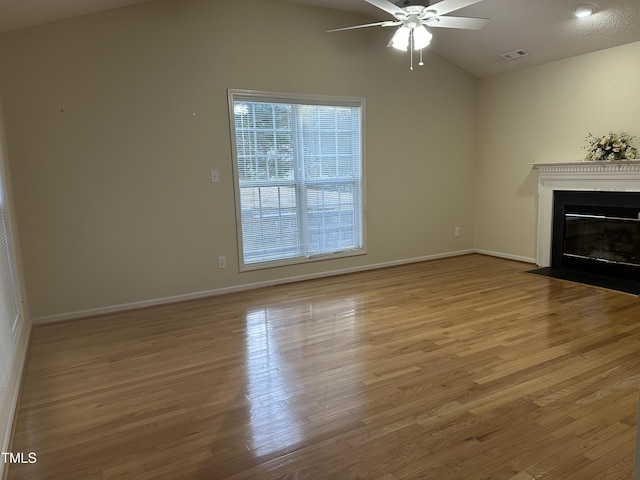 100 W Acres Cres, Cary, NC 27519 - unfurnished living room with vaulted ceiling, ceiling fan, a fireplace with flush hearth, and wood finished floors