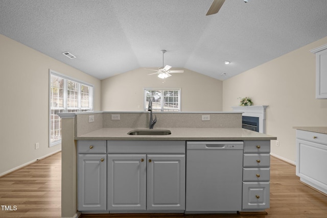 100 W Acres Cres, Cary, NC 27519 - kitchen featuring dishwasher, a ceiling fan, light wood finished floors, vaulted ceiling, and a textured ceiling