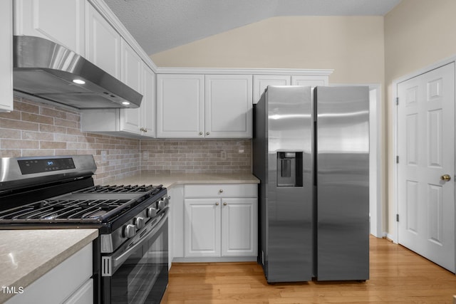 100 W Acres Cres, Cary, NC 27519 - kitchen featuring stainless steel appliances, wall chimney range hood, lofted ceiling, white cabinetry, and light countertops