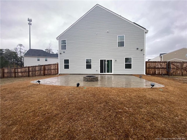 4671 Revelstroke Rd, Hope Mills, NC 28348 - rear view of house featuring a patio area, a fenced backyard, and a fire pit