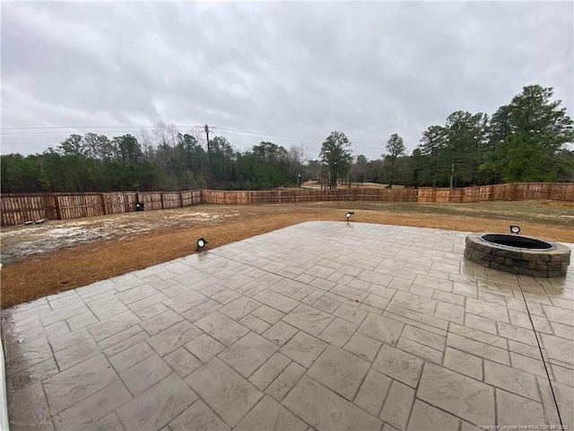 4671 Revelstroke Rd, Hope Mills, NC 28348 - fenced backyard featuring an outdoor fire pit and a patio area