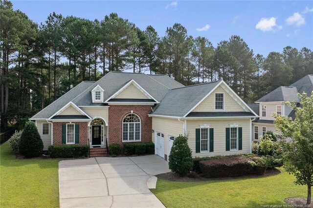 259 Rolling Pines Dr, Spring Lake, NC 28390 - view of front of property featuring driveway, a front yard, a garage, and brick siding
