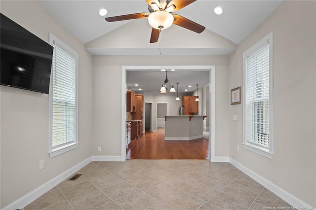259 Rolling Pines Dr, Spring Lake, NC 28390 - unfurnished living room featuring vaulted ceiling, a ceiling fan, light tile patterned flooring, and recessed lighting