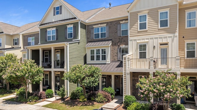 417 Austin View Blvd, Wake Forest, NC 27587 - townhome / multi-family property featuring board and batten siding, brick siding, a standing seam roof, and a metal roof