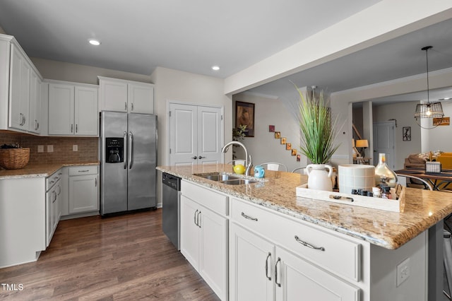 417 Austin View Blvd, Wake Forest, NC 27587 - kitchen featuring stainless steel appliances, light stone counters, a kitchen island with sink, decorative backsplash, and recessed lighting