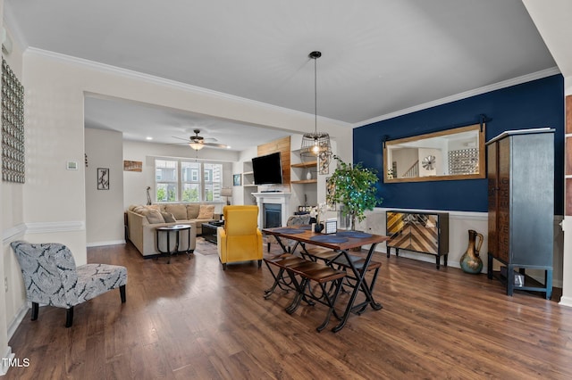 417 Austin View Blvd, Wake Forest, NC 27587 - dining space with a fireplace, dark wood-style flooring, a ceiling fan, and crown molding