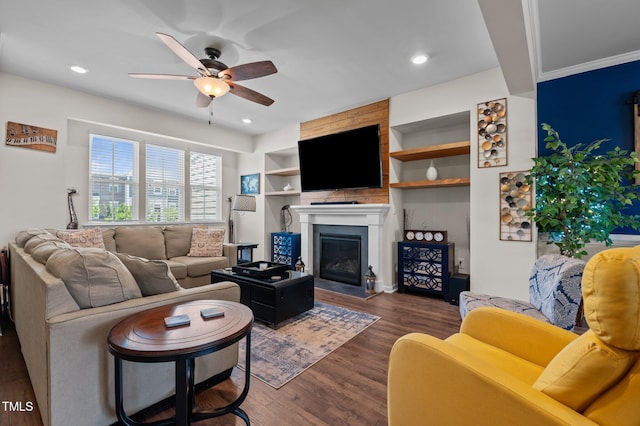 417 Austin View Blvd, Wake Forest, NC 27587 - living room with ceiling fan, dark wood-style flooring, a large fireplace, built in features, and recessed lighting