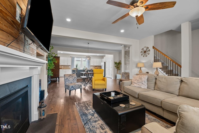417 Austin View Blvd, Wake Forest, NC 27587 - living room featuring dark wood-style flooring, ceiling fan, a glass covered fireplace, recessed lighting, and stairway