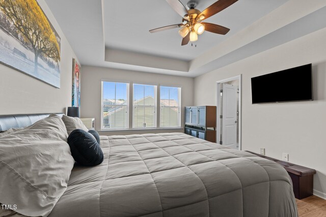 417 Austin View Blvd, Wake Forest, NC 27587 - bedroom with wood finished floors, a tray ceiling, and ceiling fan