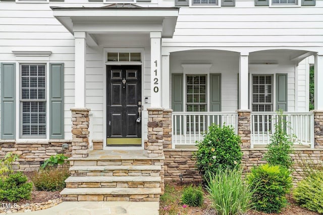 1120 Colonial Club Rd, Wake Forest, NC 27587 - property entrance featuring stone siding and a porch
