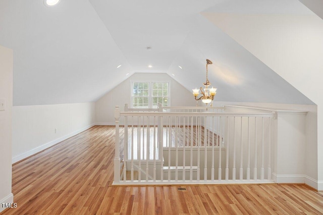 1120 Colonial Club Rd, Wake Forest, NC 27587 - bonus room with a chandelier, vaulted ceiling, and wood finished floors