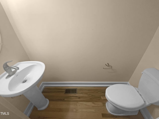 495 Ruth Cir, Fuquay Varina, NC 27526 - half bathroom featuring baseboards and wood finished floors