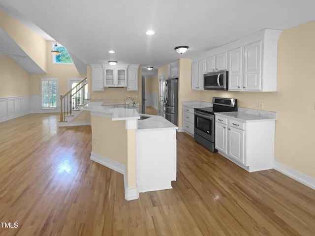 495 Ruth Cir, Fuquay Varina, NC 27526 - kitchen featuring stainless steel appliances, light wood-type flooring, white cabinets, light countertops, and recessed lighting