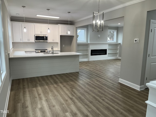 3204 Overlook Ct, Burlington, NC 27215 - kitchen featuring stainless steel microwave, crown molding, white cabinets, range, and dark wood-type flooring