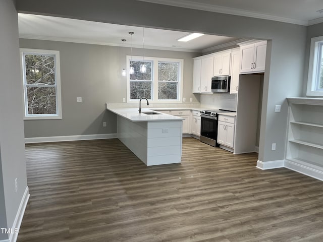 3204 Overlook Ct, Burlington, NC 27215 - kitchen with appliances with stainless steel finishes, a peninsula, white cabinetry, dark wood-style flooring, and crown molding