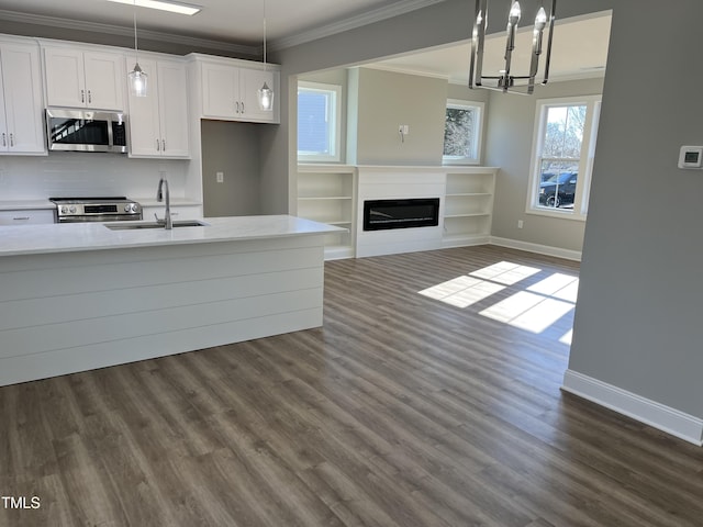 3204 Overlook Ct, Burlington, NC 27215 - kitchen with stainless steel appliances, crown molding, light countertops, white cabinets, and dark wood-type flooring