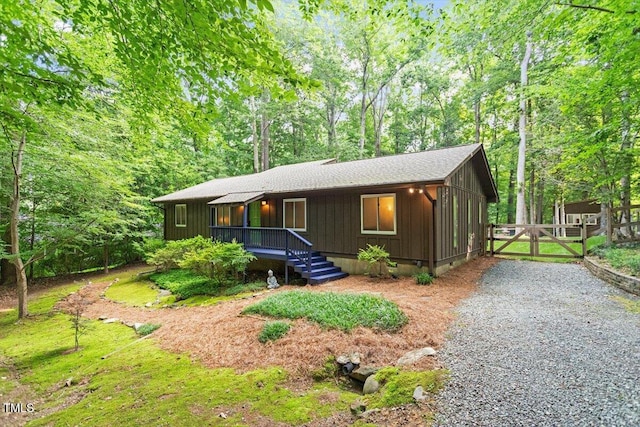 1403 Meadow Ln, Chapel Hill, NC 27516 - view of front facade with a gate, board and batten siding, and a shingled roof