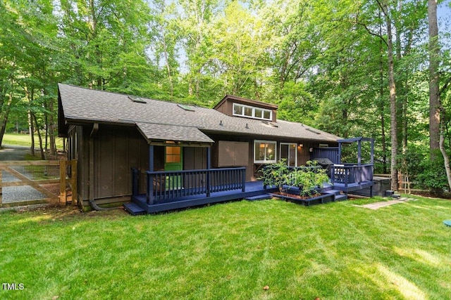 1403 Meadow Ln, Chapel Hill, NC 27516 - back of property with a lawn, roof with shingles, and a wooden deck