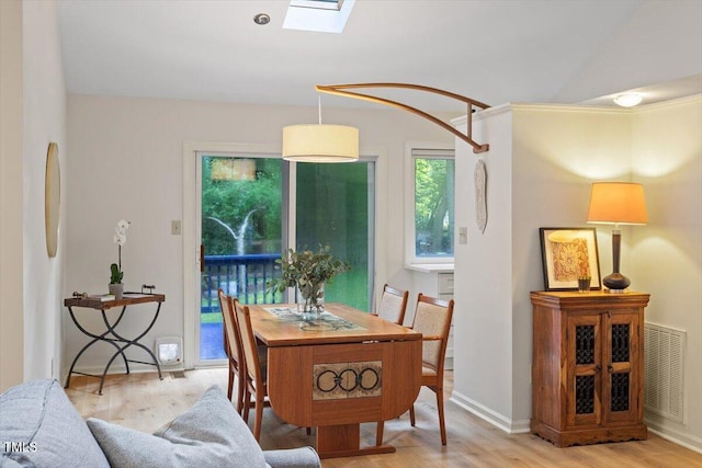 1403 Meadow Ln, Chapel Hill, NC 27516 - dining room with a skylight, wood finished floors, and lofted ceiling