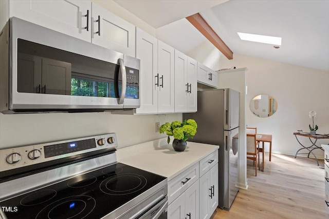 1403 Meadow Ln, Chapel Hill, NC 27516 - kitchen featuring appliances with stainless steel finishes, white cabinetry, light wood-type flooring, and light countertops