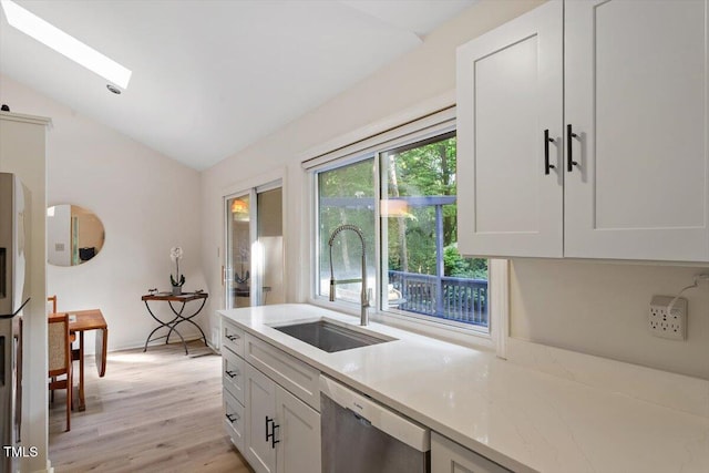 1403 Meadow Ln, Chapel Hill, NC 27516 - kitchen with dishwasher, lofted ceiling, light wood-style flooring, and white cabinets