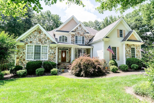 5920 Two Pines Trl, Wake Forest, NC 27587 - view of front of property with stone siding, a front yard, and roof with shingles