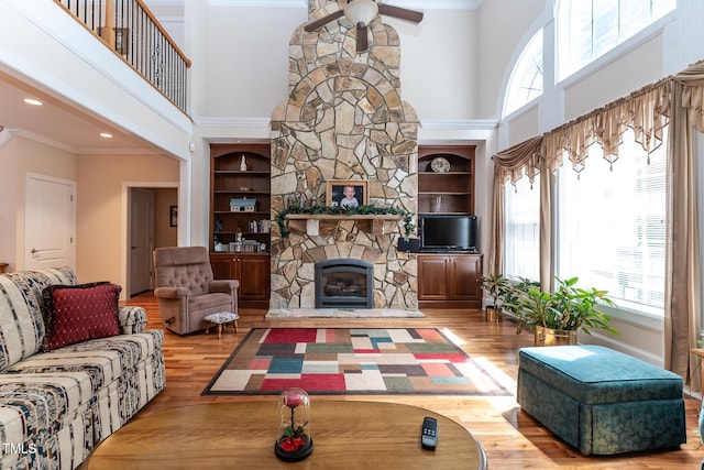 5920 Two Pines Trl, Wake Forest, NC 27587 - living room with a towering ceiling, plenty of natural light, ceiling fan, a stone fireplace, and wood finished floors
