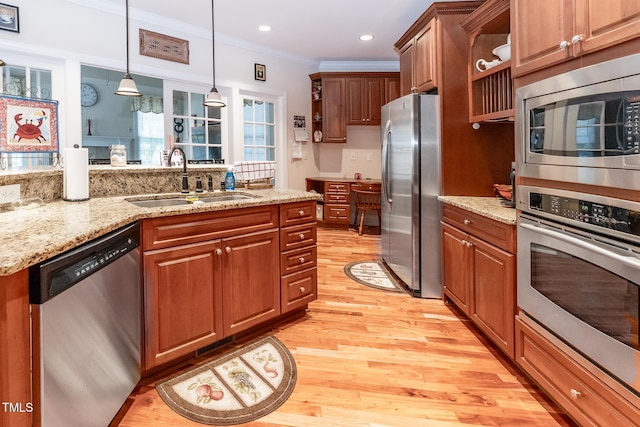5920 Two Pines Trl, Wake Forest, NC 27587 - kitchen featuring appliances with stainless steel finishes, ornamental molding, open shelves, light wood-style flooring, and hanging light fixtures