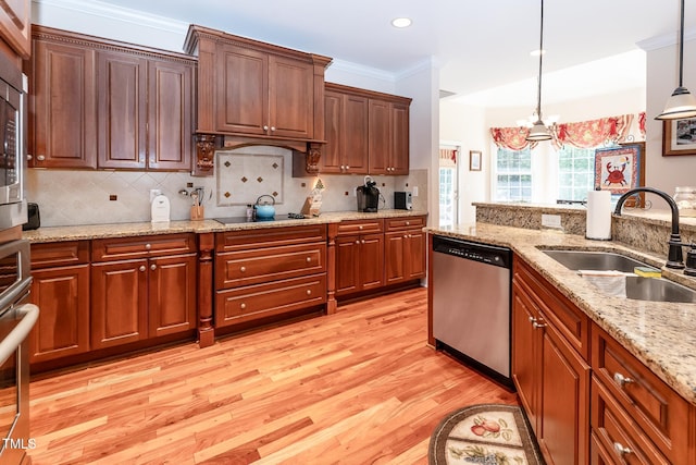 5920 Two Pines Trl, Wake Forest, NC 27587 - kitchen featuring appliances with stainless steel finishes, light wood-style flooring, decorative light fixtures, a chandelier, and decorative backsplash