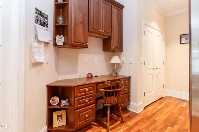 5920 Two Pines Trl, Wake Forest, NC 27587 - home office featuring built in desk, light wood-style flooring, and ornamental molding