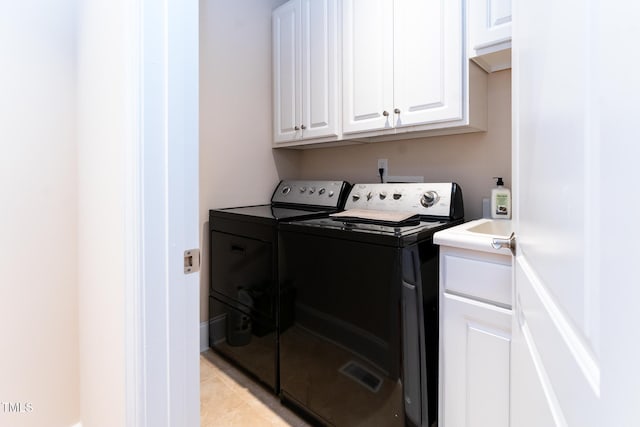 5920 Two Pines Trl, Wake Forest, NC 27587 - laundry area with washer and clothes dryer, cabinet space, and light tile patterned floors