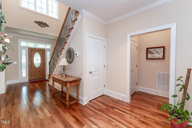 5920 Two Pines Trl, Wake Forest, NC 27587 - entrance foyer with light wood-style floors, stairway, and ornamental molding