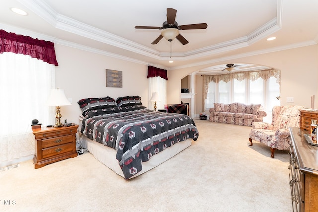 5920 Two Pines Trl, Wake Forest, NC 27587 - bedroom with arched walkways, a tray ceiling, crown molding, carpet, and ceiling fan