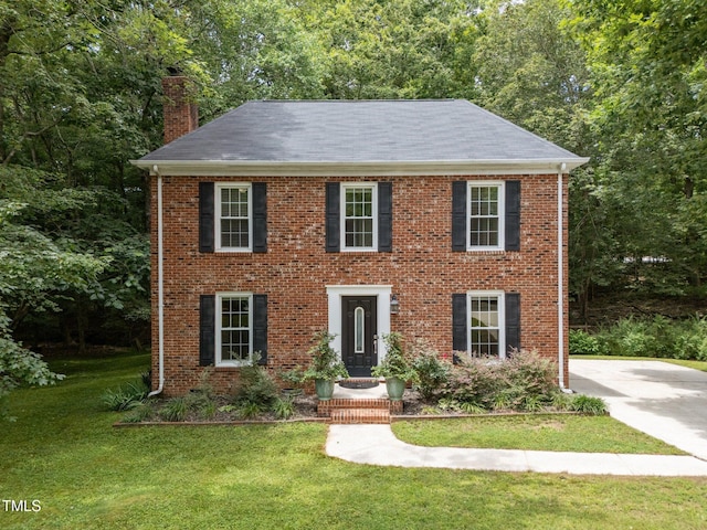 308 Trappers Sack Rd, Cary, NC 27513 - colonial inspired home featuring a chimney, a front lawn, and brick siding