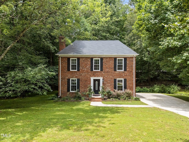 308 Trappers Sack Rd, Cary, NC 27513 - colonial inspired home with a chimney, a front yard, and brick siding